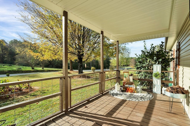 wooden deck featuring a yard and covered porch