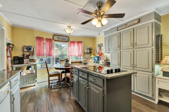 kitchen with dark hardwood / wood-style floors, ornamental molding, black electric stovetop, and a center island