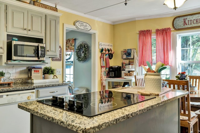 kitchen featuring cream cabinets, light stone counters, crown molding, white dishwasher, and black electric cooktop