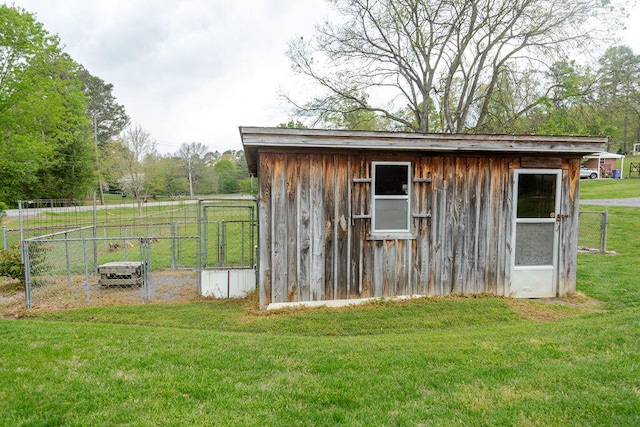 view of outbuilding with an outdoor structure and fence