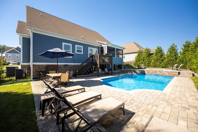 view of swimming pool featuring a patio and a deck