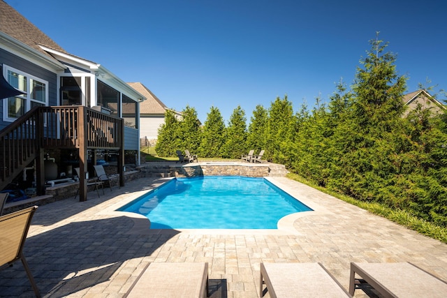 view of swimming pool with a patio