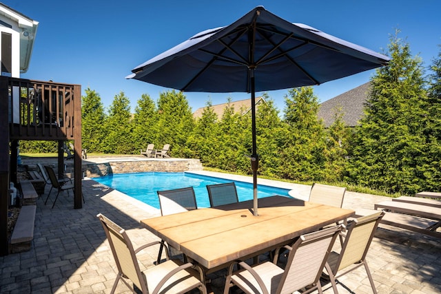 view of swimming pool with a wooden deck and a patio