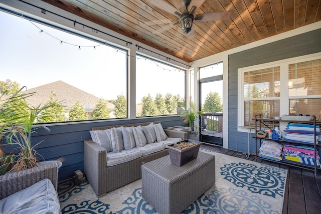 sunroom with ceiling fan and wood ceiling