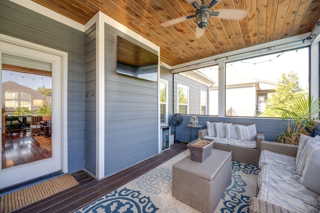 sunroom / solarium featuring ceiling fan and wooden ceiling