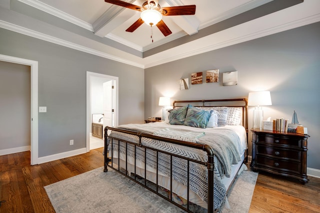 bedroom featuring connected bathroom, ceiling fan, dark hardwood / wood-style flooring, and ornamental molding