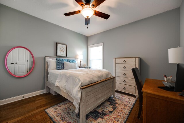 bedroom with ceiling fan and dark wood-type flooring