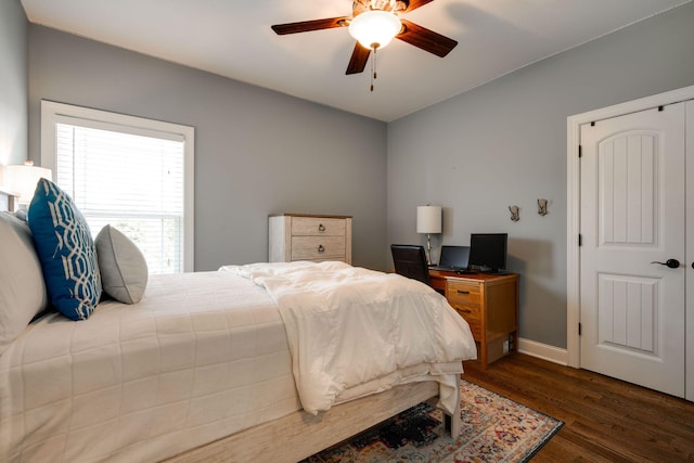 bedroom with ceiling fan and dark wood-type flooring