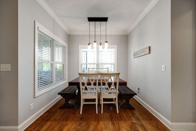 dining area with crown molding and dark hardwood / wood-style floors