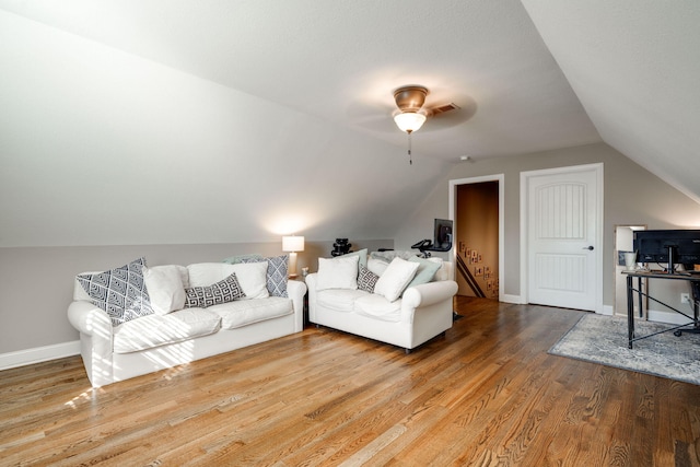 living room with hardwood / wood-style floors, vaulted ceiling, and ceiling fan