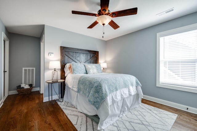 bedroom featuring hardwood / wood-style floors and ceiling fan