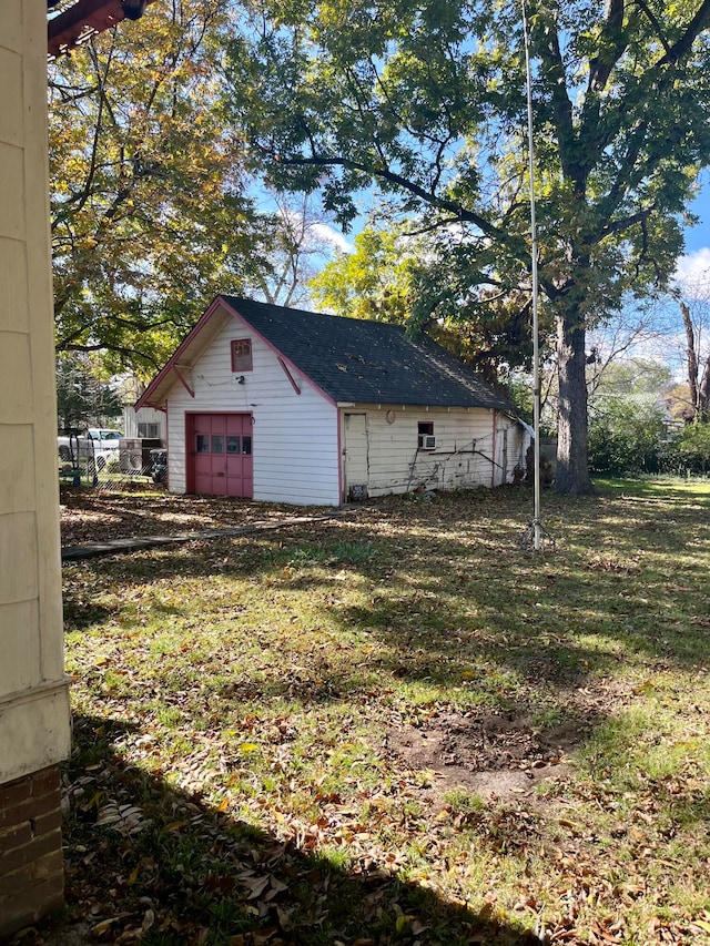 exterior space with an outbuilding and a garage