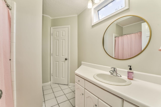 bathroom featuring vanity, a textured ceiling, tile patterned flooring, and ornamental molding