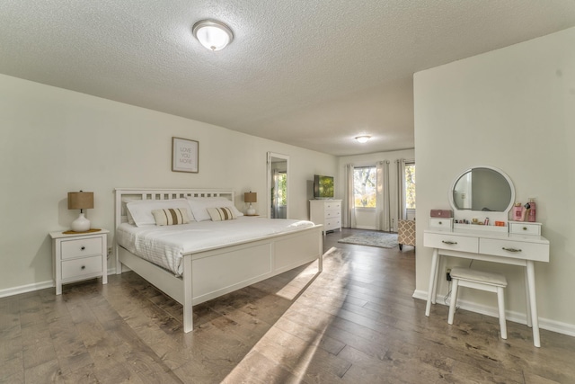 bedroom featuring wood-type flooring and a textured ceiling