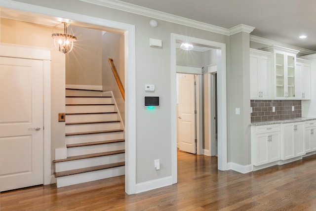 8556 Festival Loop, Chattanooga, TN 37419 - staircase with wood finished floors, crown molding, baseboards, a chandelier, and recessed lighting