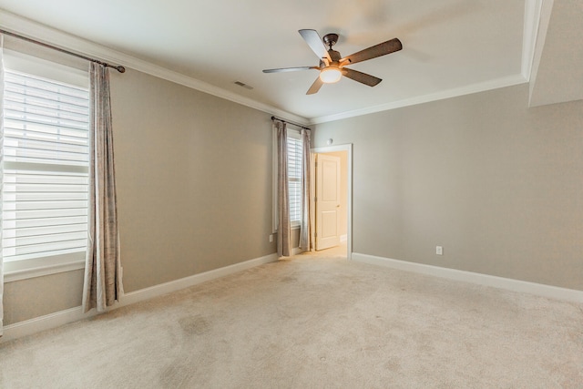 carpeted spare room featuring ceiling fan and ornamental molding