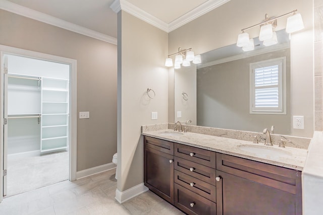 bathroom featuring vanity, toilet, and crown molding