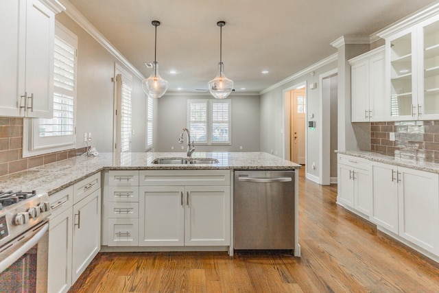 kitchen featuring light wood-type flooring, stainless steel appliances, white cabinetry, and sink