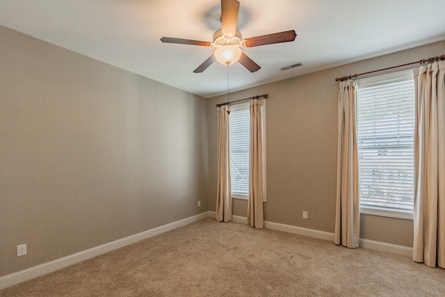 unfurnished room with light carpet, ceiling fan, and a healthy amount of sunlight