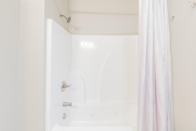 bathroom with shower / bath combo with shower curtain