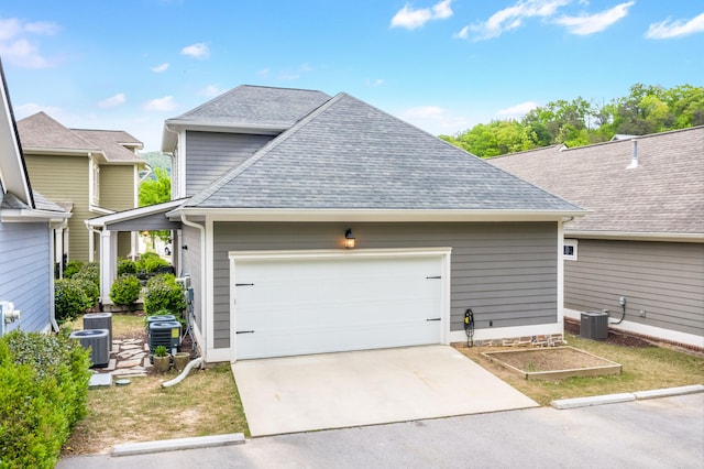 view of front of house featuring central AC and a garage