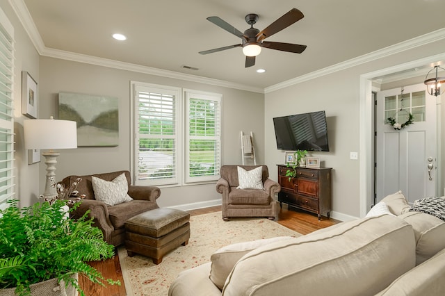 living room with crown molding, hardwood / wood-style floors, and ceiling fan