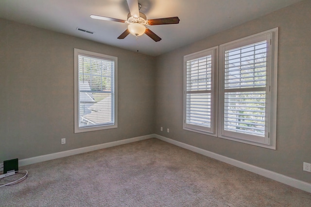 unfurnished room featuring ceiling fan and light carpet