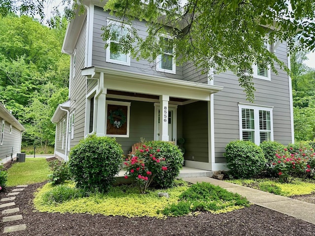 view of front of home featuring covered porch and cooling unit