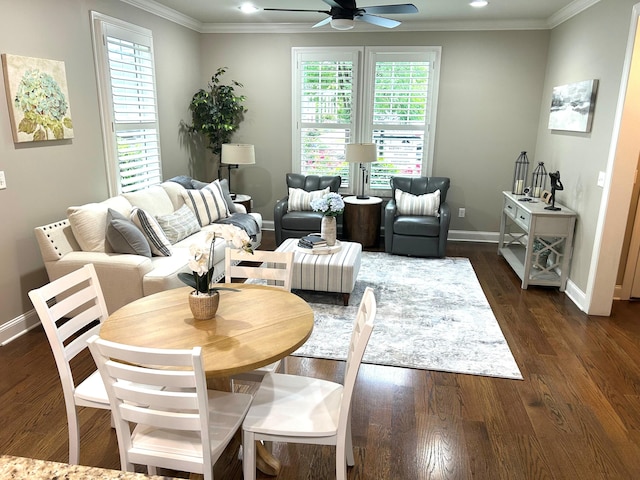 living area with baseboards, ornamental molding, ceiling fan, and a healthy amount of sunlight