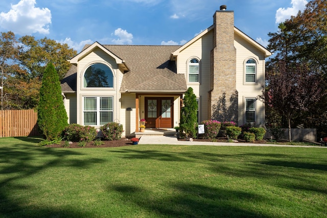 view of property featuring french doors and a front lawn