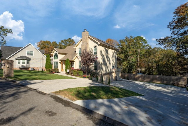 view of front of house with a front yard and a garage