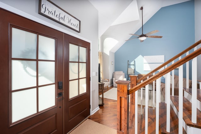 foyer entrance with ceiling fan, high vaulted ceiling, and dark hardwood / wood-style floors