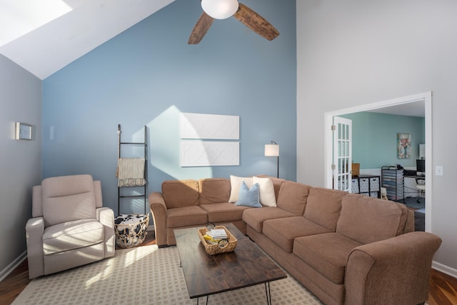 living room with hardwood / wood-style floors, high vaulted ceiling, and ceiling fan