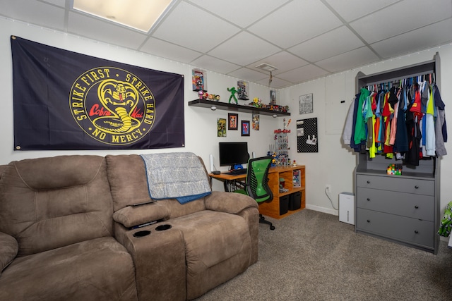 living room with carpet and a paneled ceiling