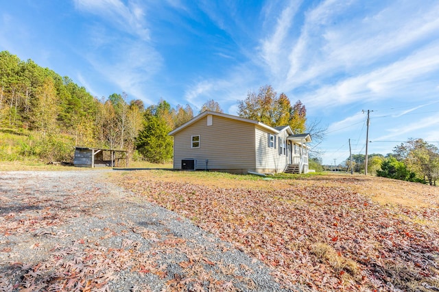 view of side of home featuring cooling unit