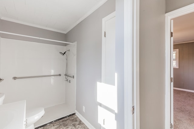 bathroom with toilet, wooden walls, ornamental molding, vanity, and a shower