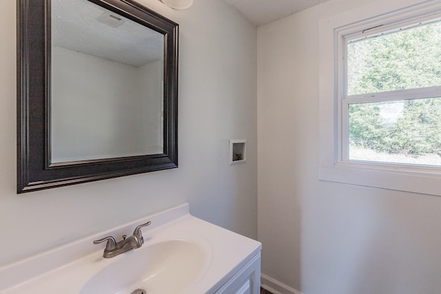 bathroom featuring vanity and a textured ceiling