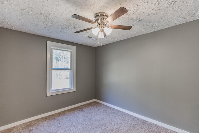 empty room featuring carpet flooring, a textured ceiling, and ceiling fan