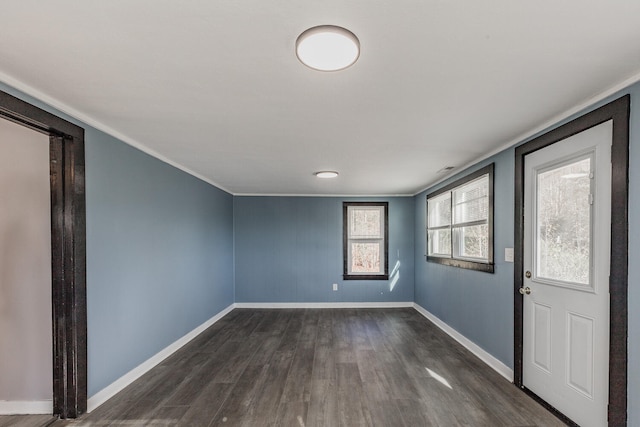 entrance foyer featuring dark wood-type flooring and crown molding