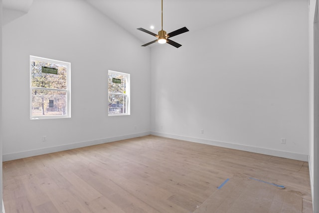 unfurnished room featuring high vaulted ceiling, light hardwood / wood-style flooring, and ceiling fan