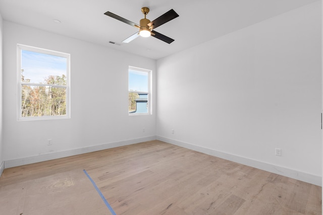 empty room featuring ceiling fan and light hardwood / wood-style floors