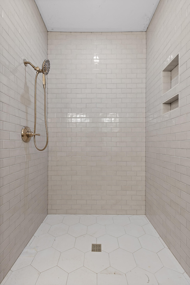 bathroom with tiled shower