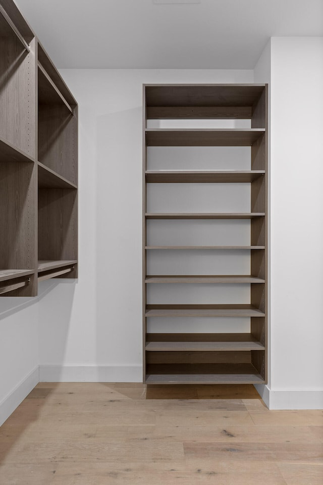 spacious closet featuring light hardwood / wood-style floors