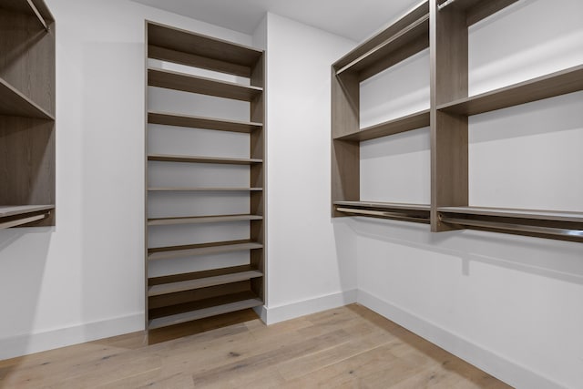 spacious closet with light hardwood / wood-style flooring