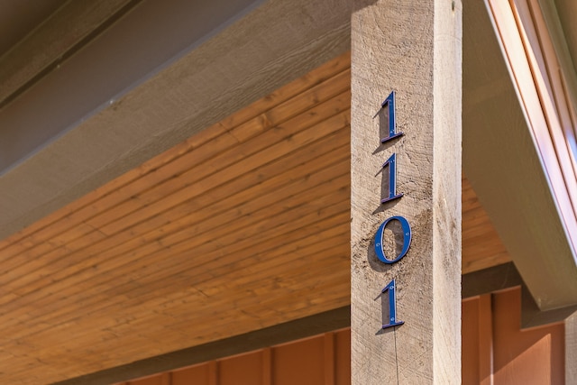 details with wood walls and wooden ceiling