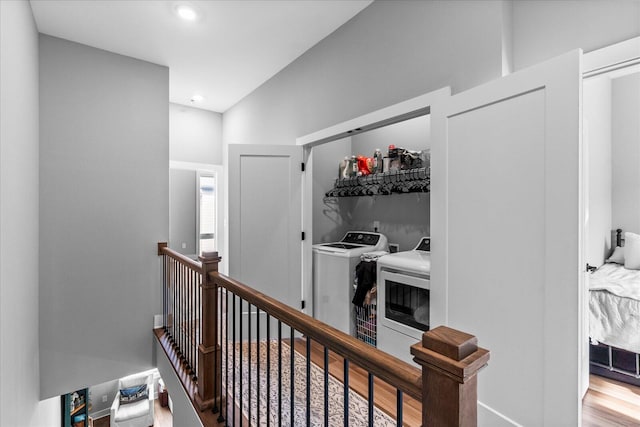 corridor with washing machine and dryer and hardwood / wood-style floors