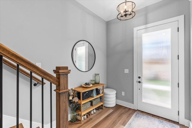 entryway with a chandelier and light wood-type flooring