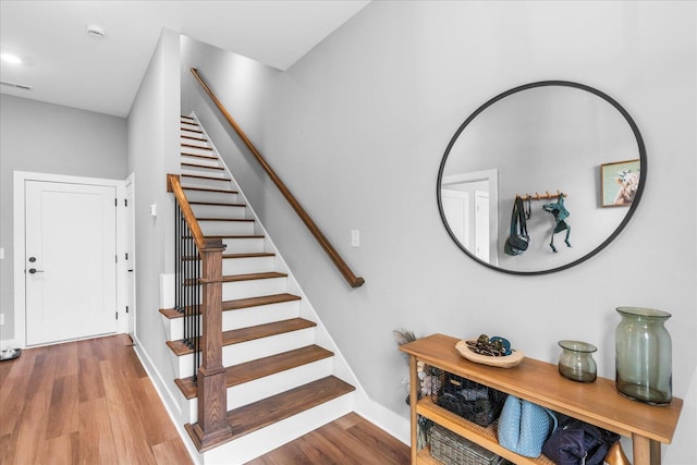 stairway featuring hardwood / wood-style floors