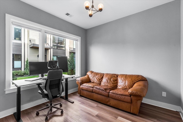 office space featuring light hardwood / wood-style flooring and a notable chandelier