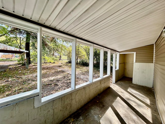 unfurnished sunroom with a wealth of natural light and vaulted ceiling